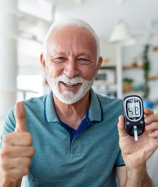 A person with diabetes holding a blood sugar monitor
