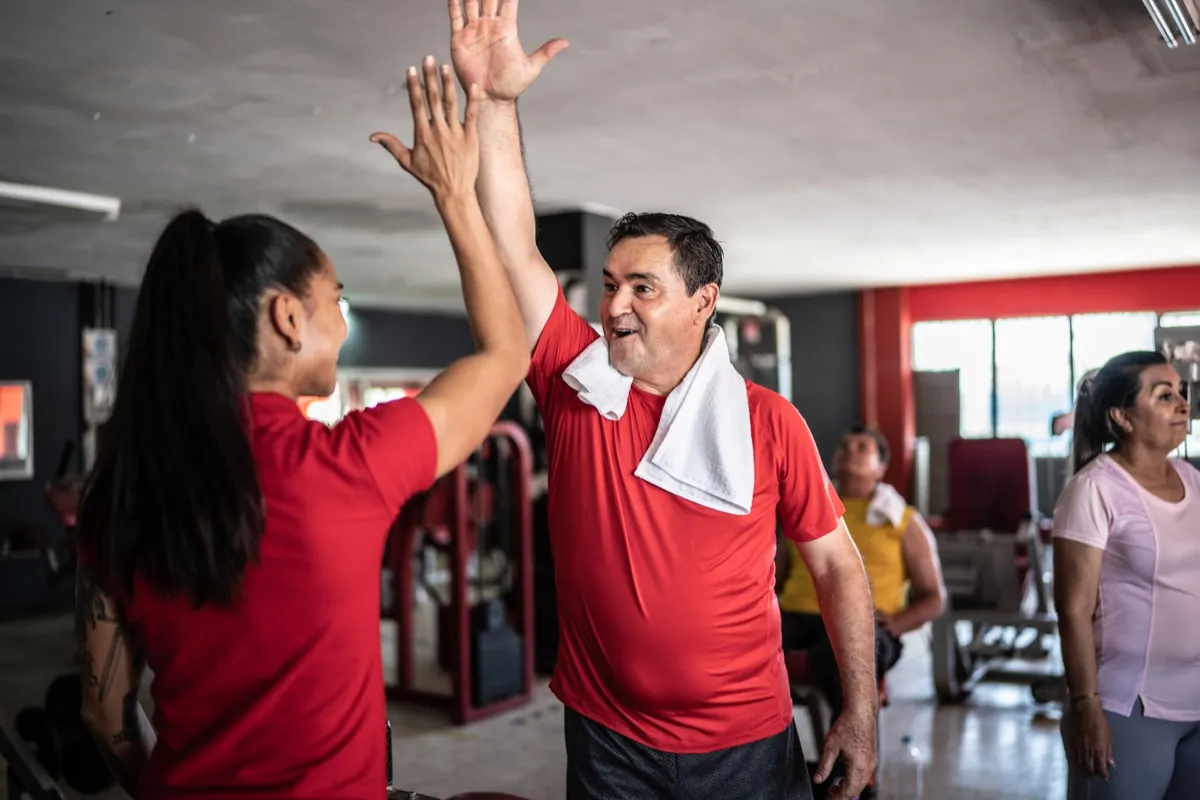 Gym members high fiving at the YMCA